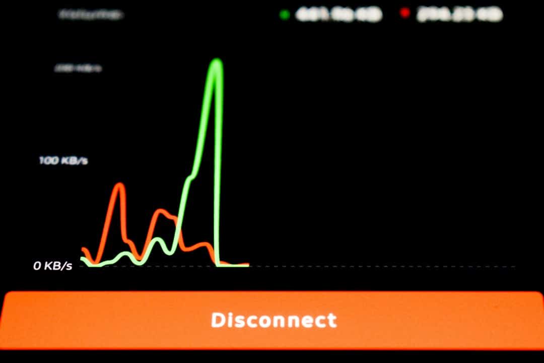 UI panel showing network activity with red and green spikes on a dark background and a large orange Disconnect button at the bottom