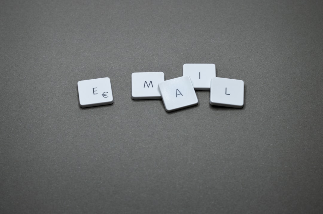 White square tiles arranged to spell the word EMAIL on a gray surface.