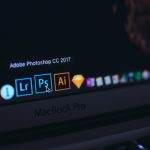 Close-up of a MacBook Pro dock showing the Adobe Photoshop CC 2017 icon highlighted, with Lightroom and Illustrator icons nearby.