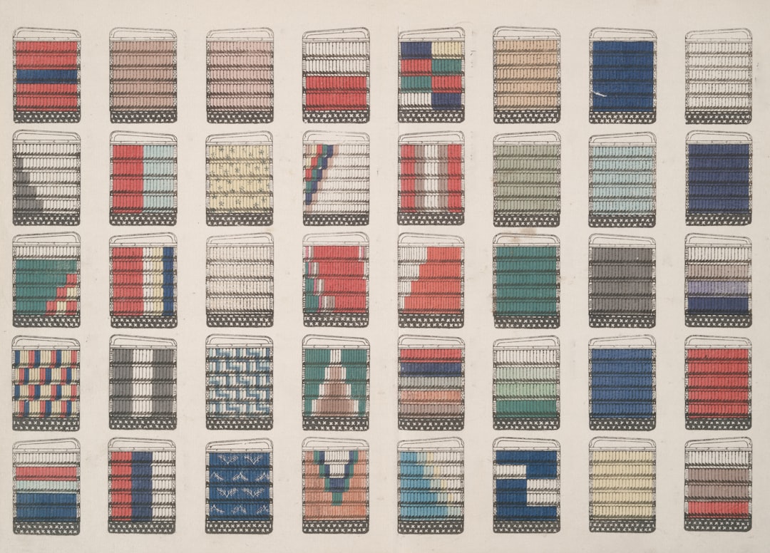 Grid of numerous small rectangular fabric color samples arranged in rows and columns on a light background.