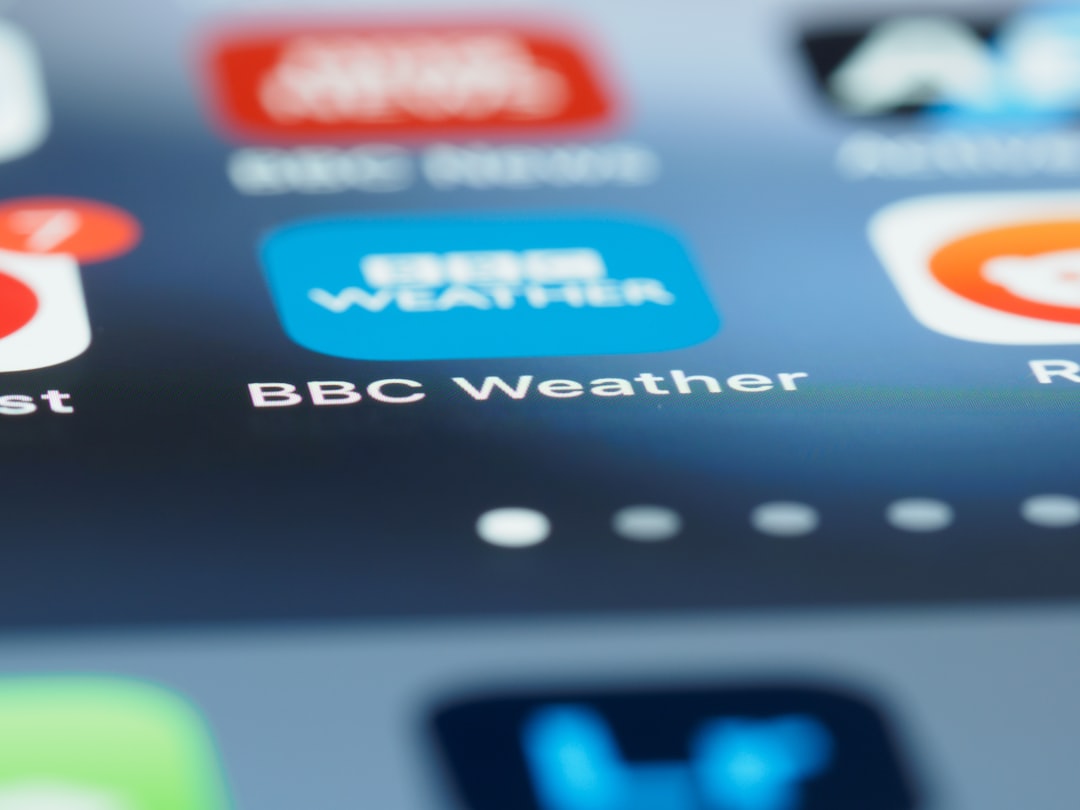 BBC Weather app icon on a smartphone home screen, with other icons blurred in the background