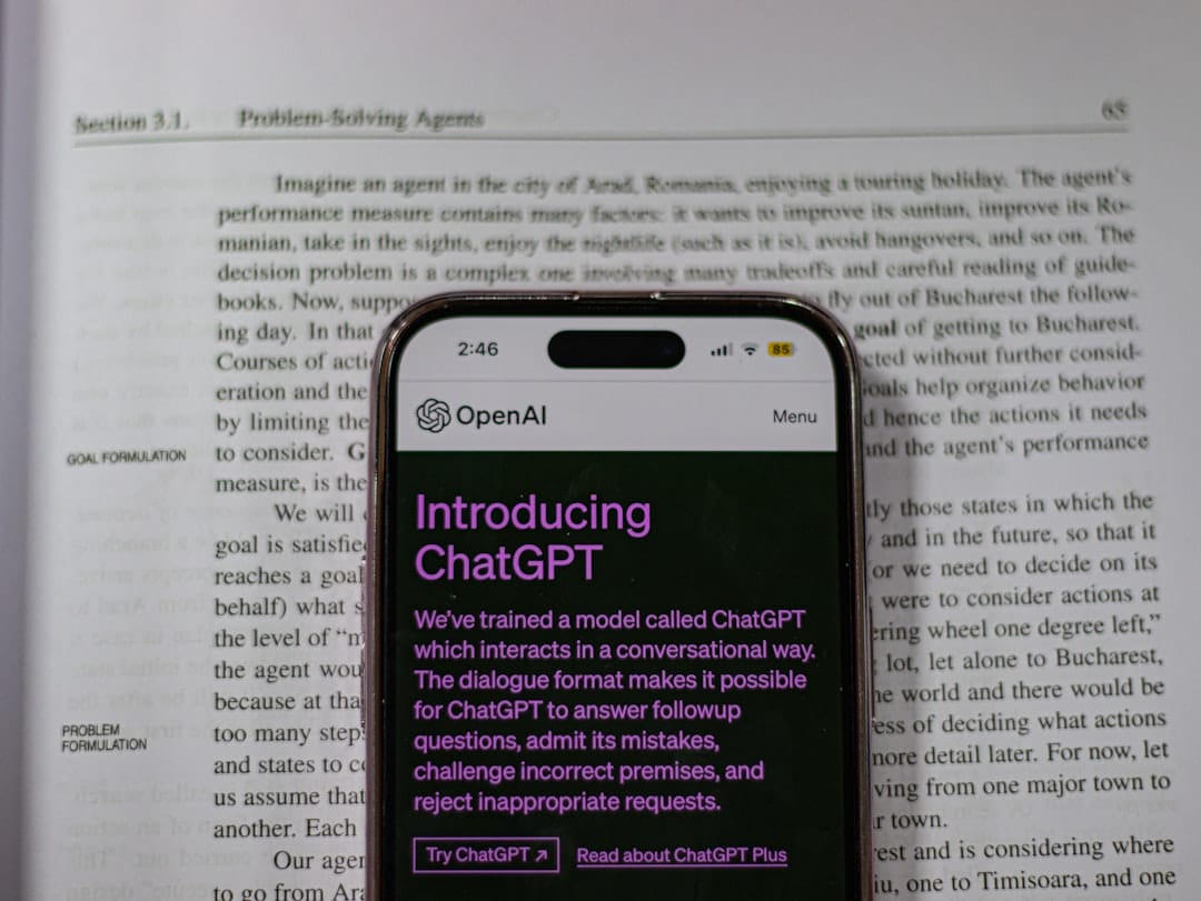 a cell phone sitting on top of an open book ai testing chatbot trials user feedback report - AI Bud