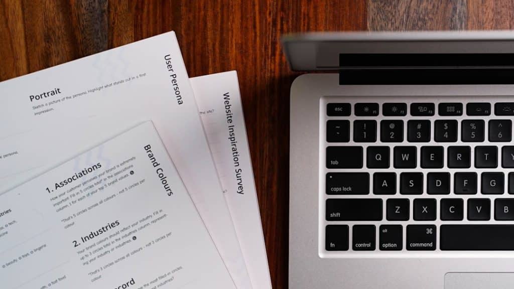 a laptop computer sitting on top of a wooden table business automation invoicing software recurring billing - AI Bud