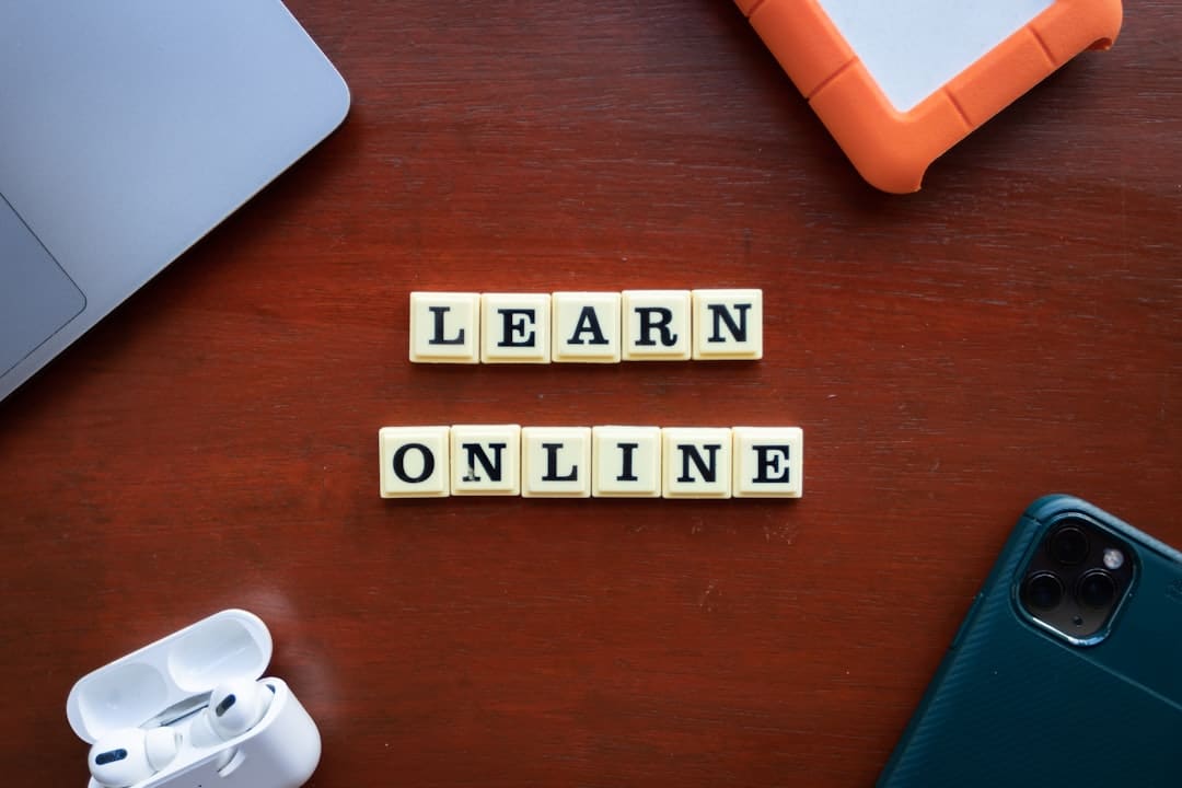 a wooden table with scrabble tiles spelling learn online online courses coding education student studying - AI Bud