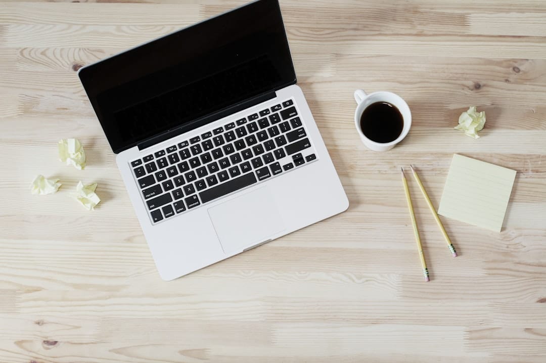 turned off MacBook Pro beside white ceramic mug filled with coffee freelance writers online tools - AI Bud