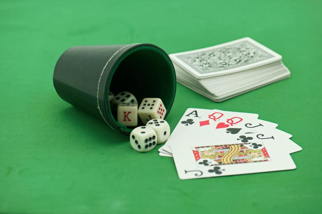 a green table with playing cards and dice affiliate marketing solitaire players mobile monetization - AI Bud