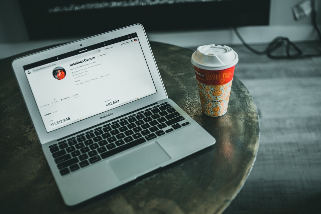 a laptop computer sitting on top of a wooden table happy users chatting online website community - AI Bud