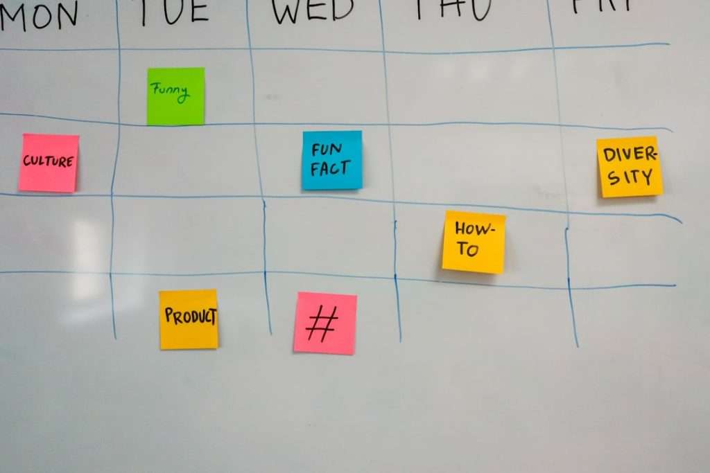 Whiteboard weekly calendar with sticky notes for topics: Culture, Funny, Fun Fact, How-To, Diversity, Product, and #.