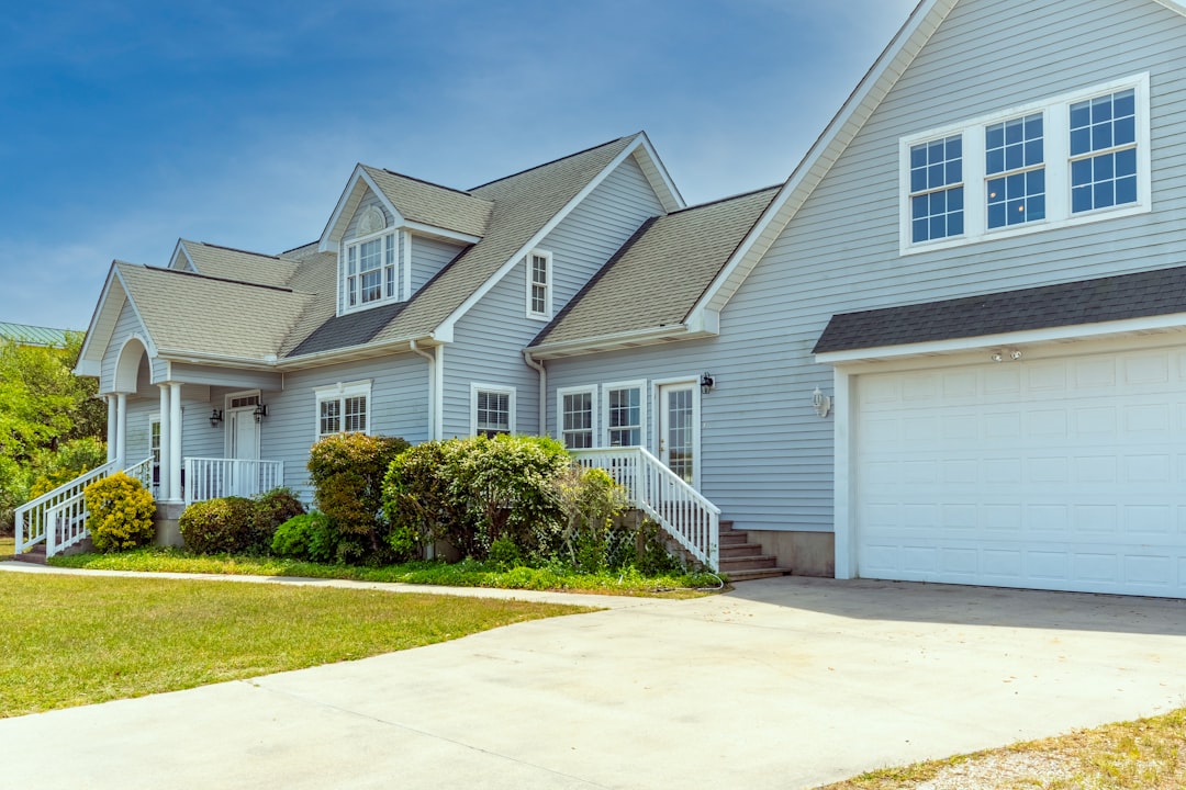 a white house with a large driveway in front of it real estate listings property management commercial properties - AI Bud