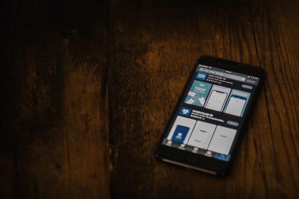 black android smartphone on brown wooden table flutter app creation website to app mobile development - AI Bud