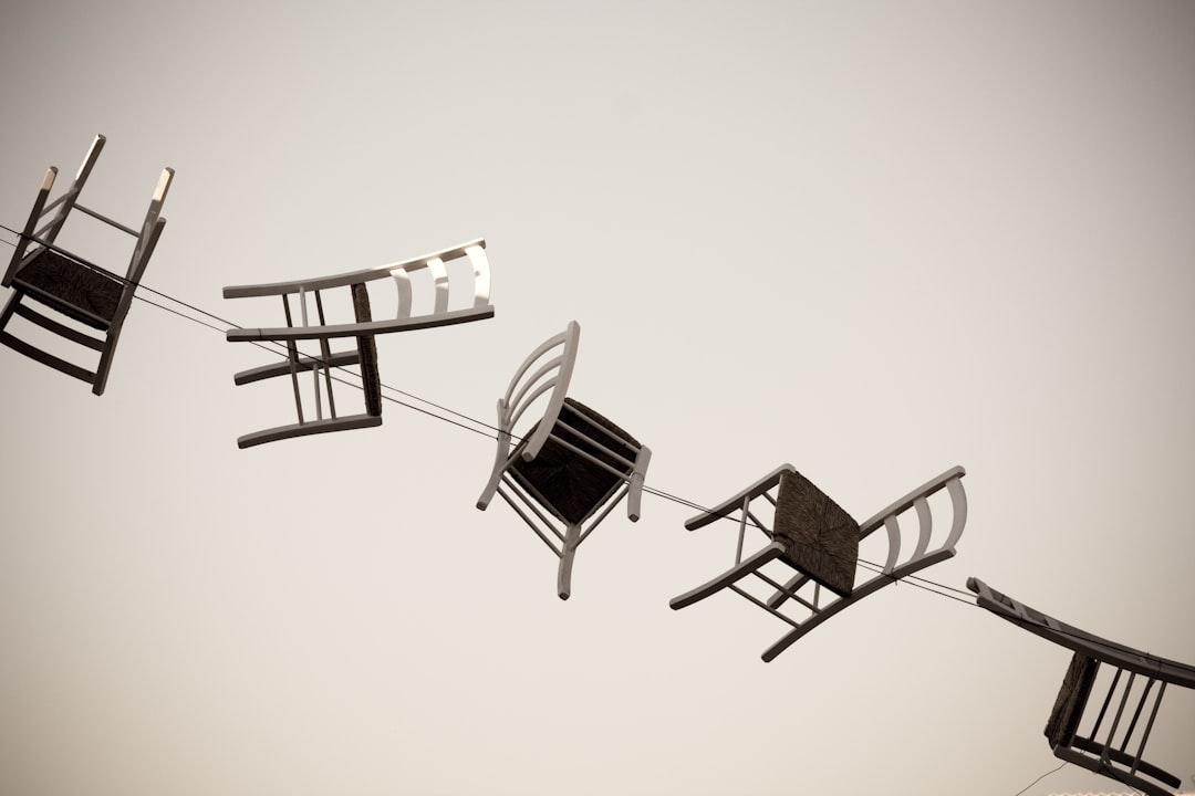 five brown wooden chairs minimalist design game interface jumping over obstacles - AI Bud