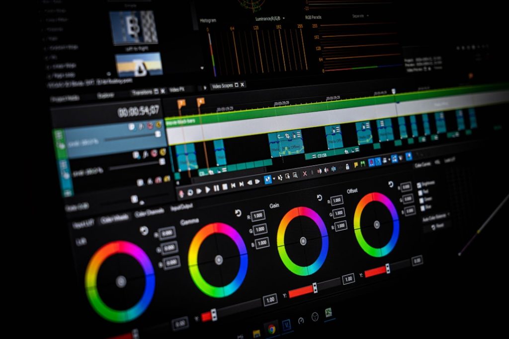 Video editing software interface showing a color grading panel with three circular color wheels on a dark screen