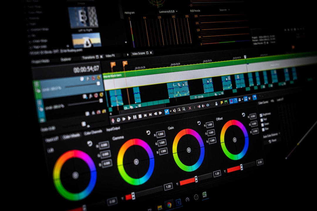 Video editing software with a dark interface, showing color grading wheels and a timeline of video clipsBelow the color wheels is a row of controls and a rich color wheel UI for grading or color correction.