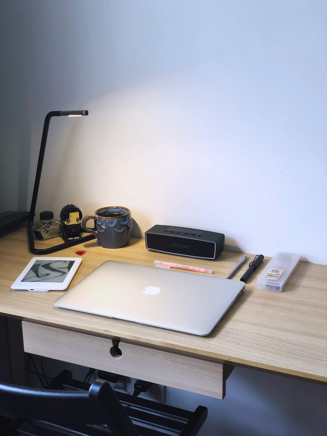 MacBook Air on table blogging tools simple interface writing desk - AI Bud