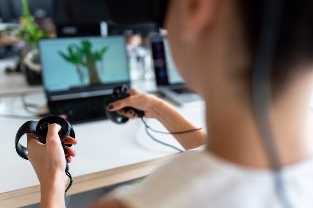person holding black game controller shortcut race casual game mobile gaming - AI Bud