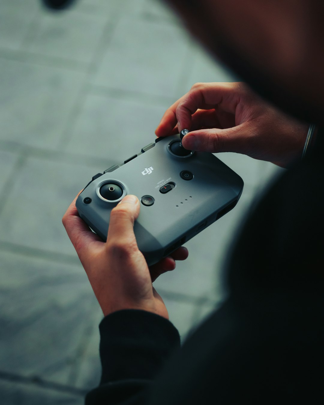 person holding gray game controller game feedback player review mobile gaming - AI Bud
