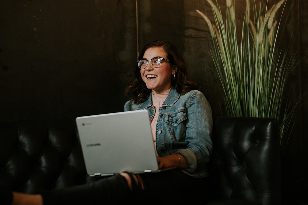 silver laptop on womans lap happy users chatting online website community - AI Bud
