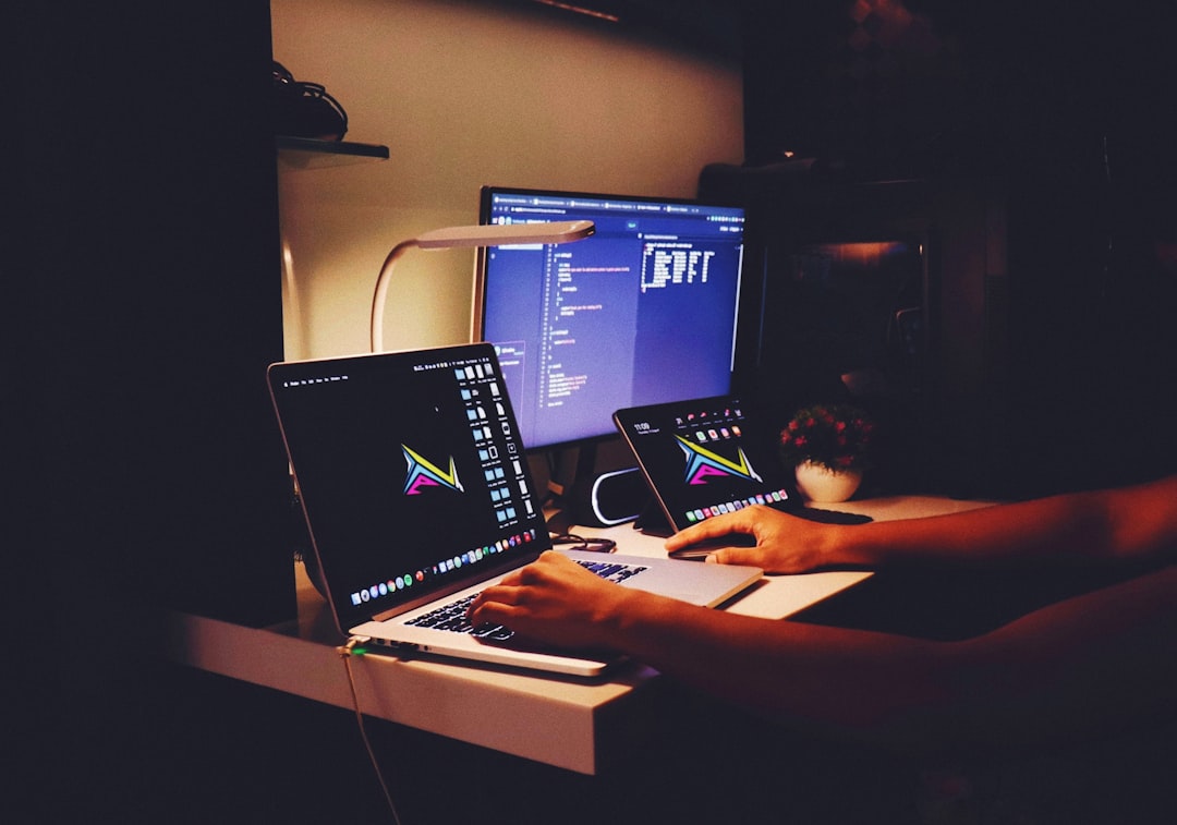 woman in black tank top sitting in front of computer website maintenance server room coding - AI Bud