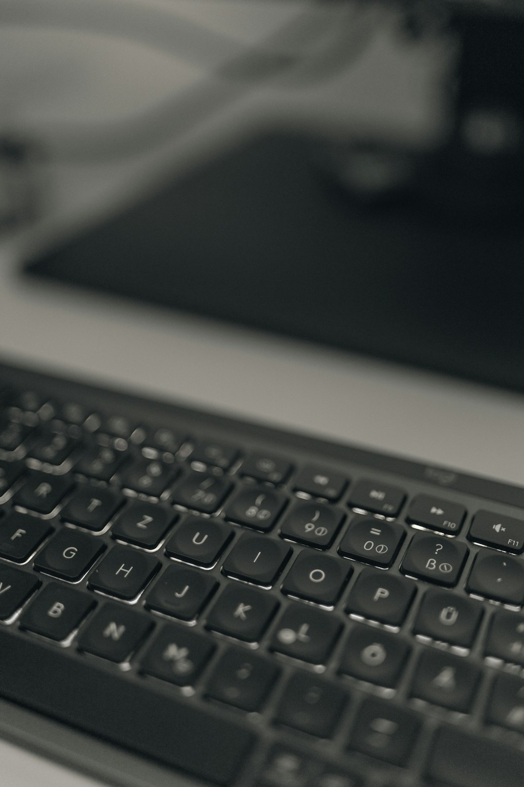 a black and white photo of a keyboard data analysis dashboard real time analytics business reporting - AI Bud