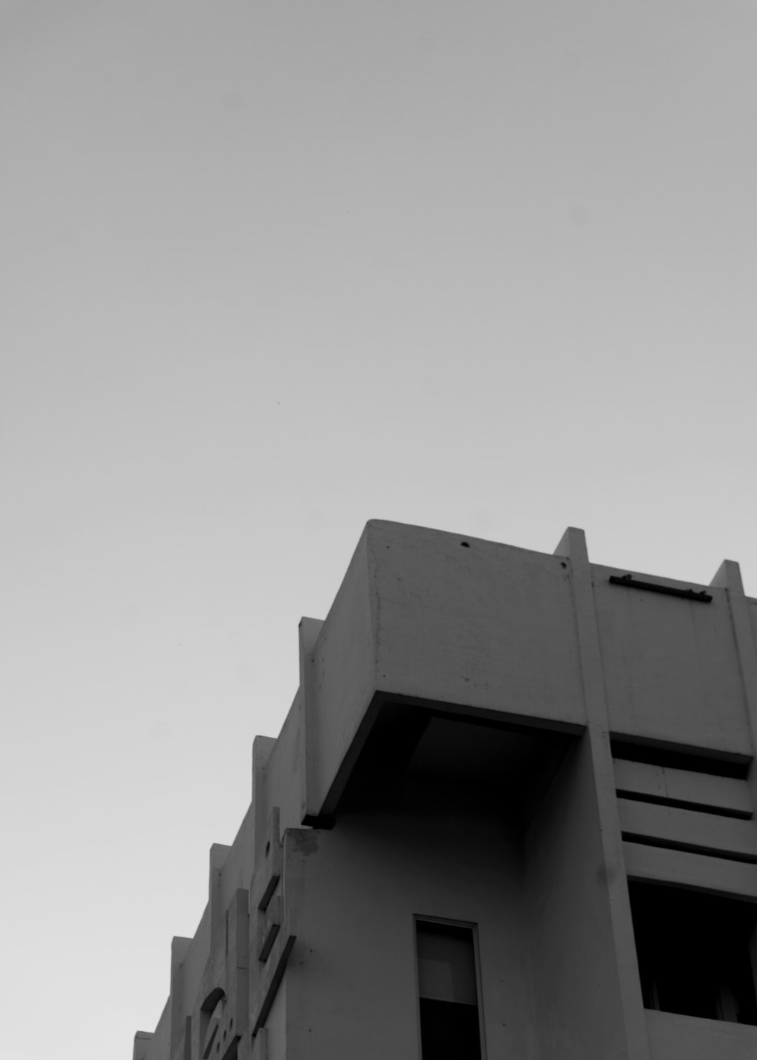 a black and white photo of a tall building zapier integromat automation workflow - AI Bud