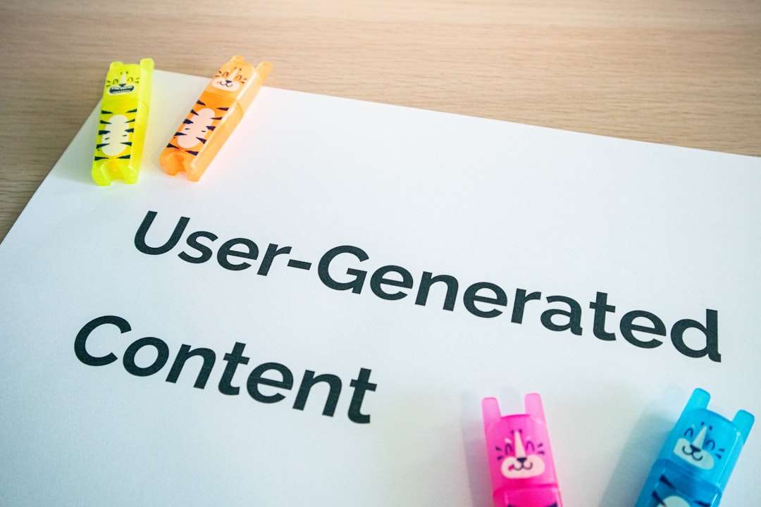 White paper on a wooden desk shows the words 'User-Generated Content' with bright, animal-shaped highlighters/clips nearby.