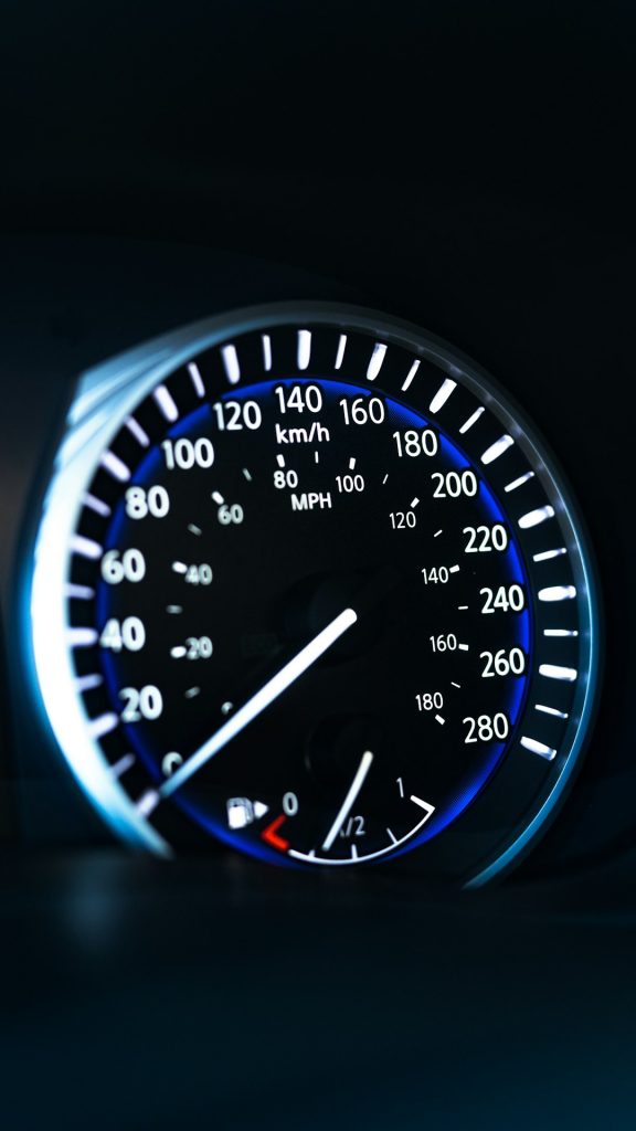 a close up of a speedometer in a car website speed optimization fast loading laptop - AI Bud