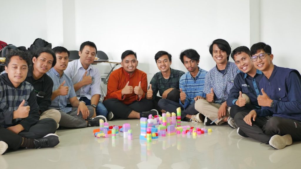 a group of men sitting next to each other team collaboration web development choosing cms - AI Bud