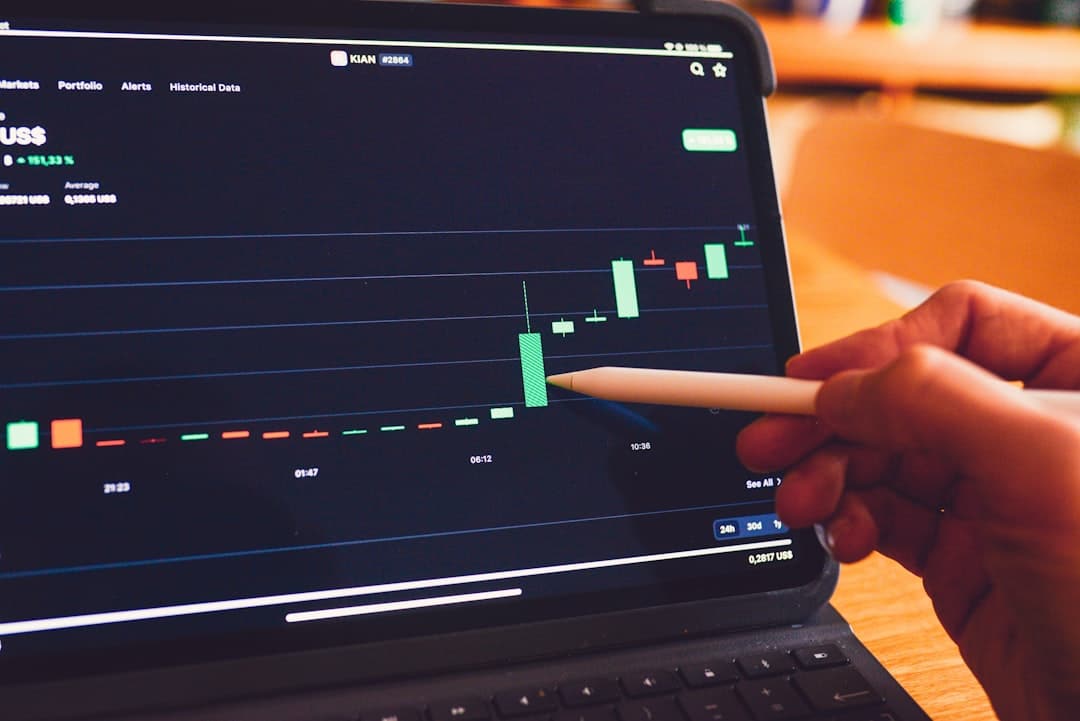 a person is holding a pencil in front of a laptop analytics dashboard laptop charts graphs - AI Bud
