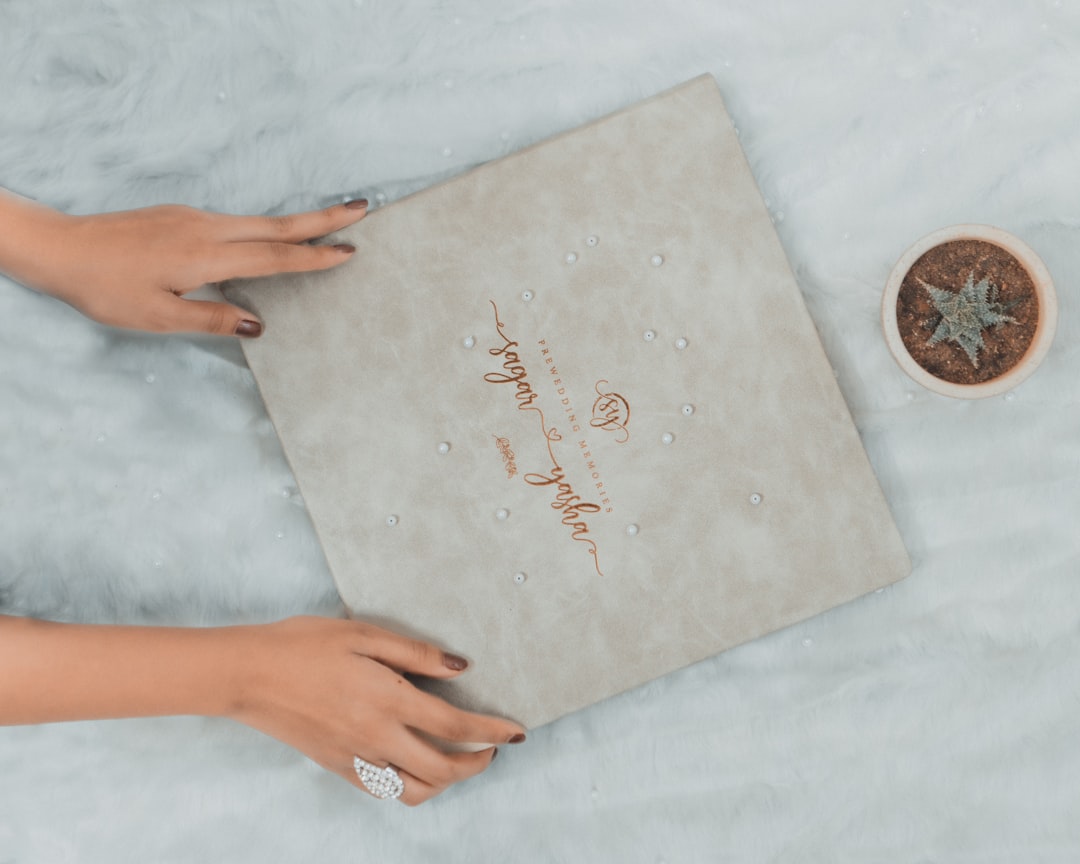 a womans hands holding a wedding ring next to a box how to guide instructions tutorial steps - AI Bud