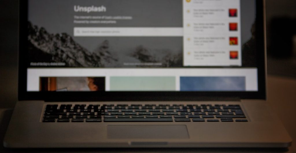 an open laptop computer sitting on top of a table website interaction click delay user frustration - AI Bud