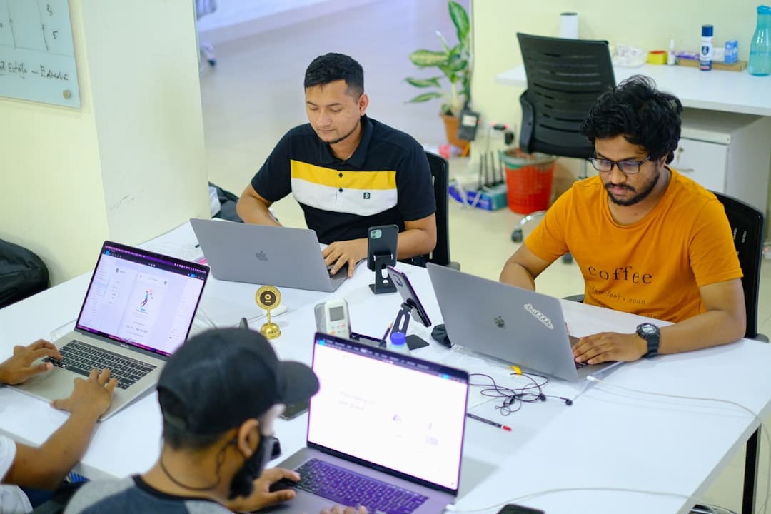 people sitting at the table using laptops team collaboration project dashboard people working - AI Bud