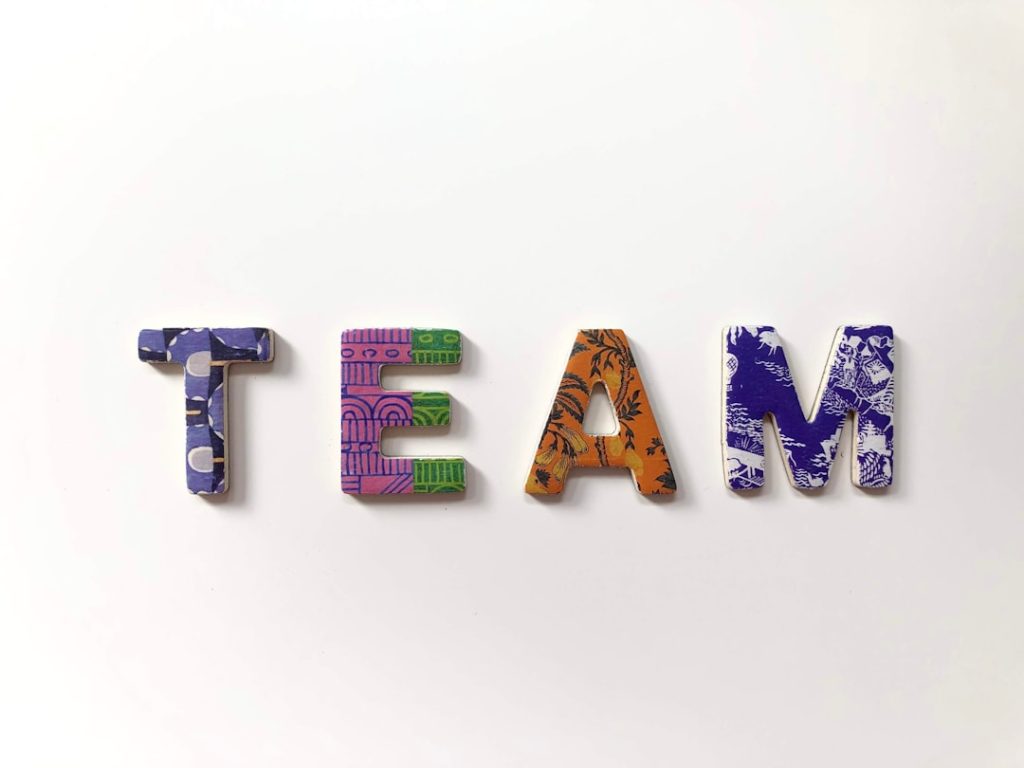 team freestanding letters team collaboration ai writing tools content planning - AI Bud