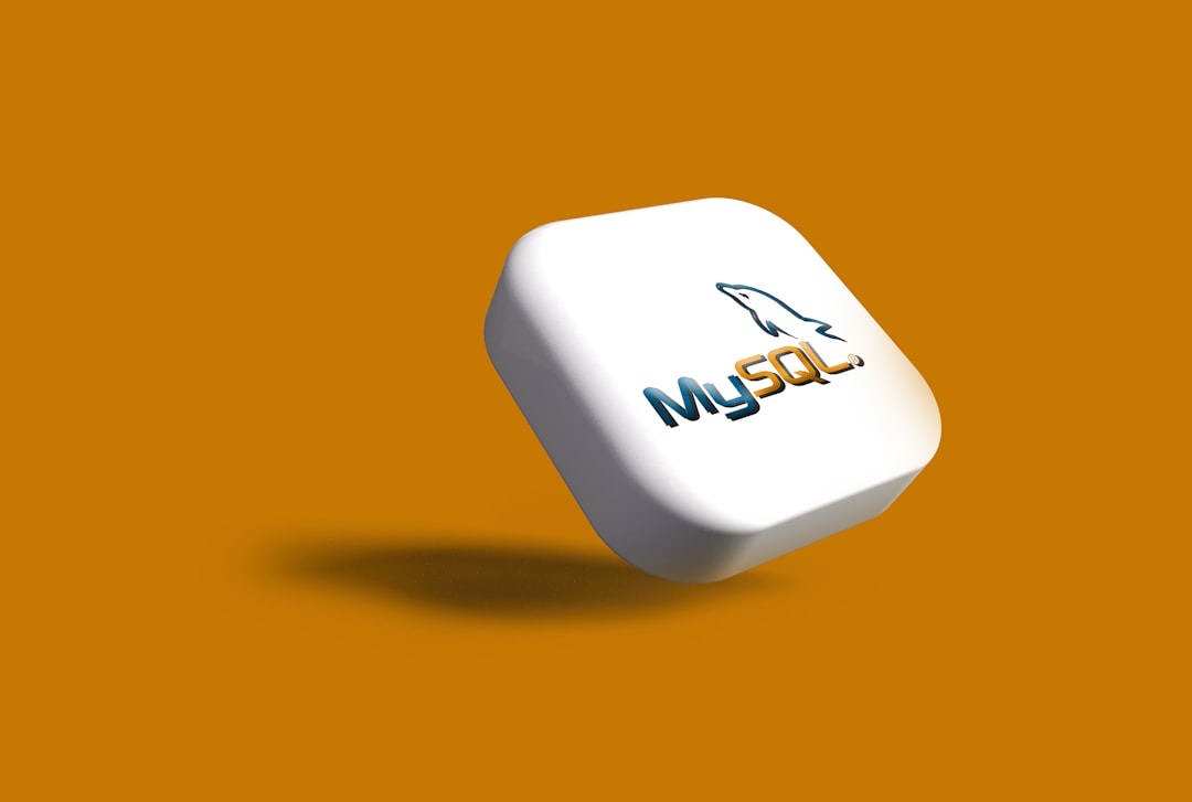 3D white rounded cube with the MySQL logo hovering over an orange background