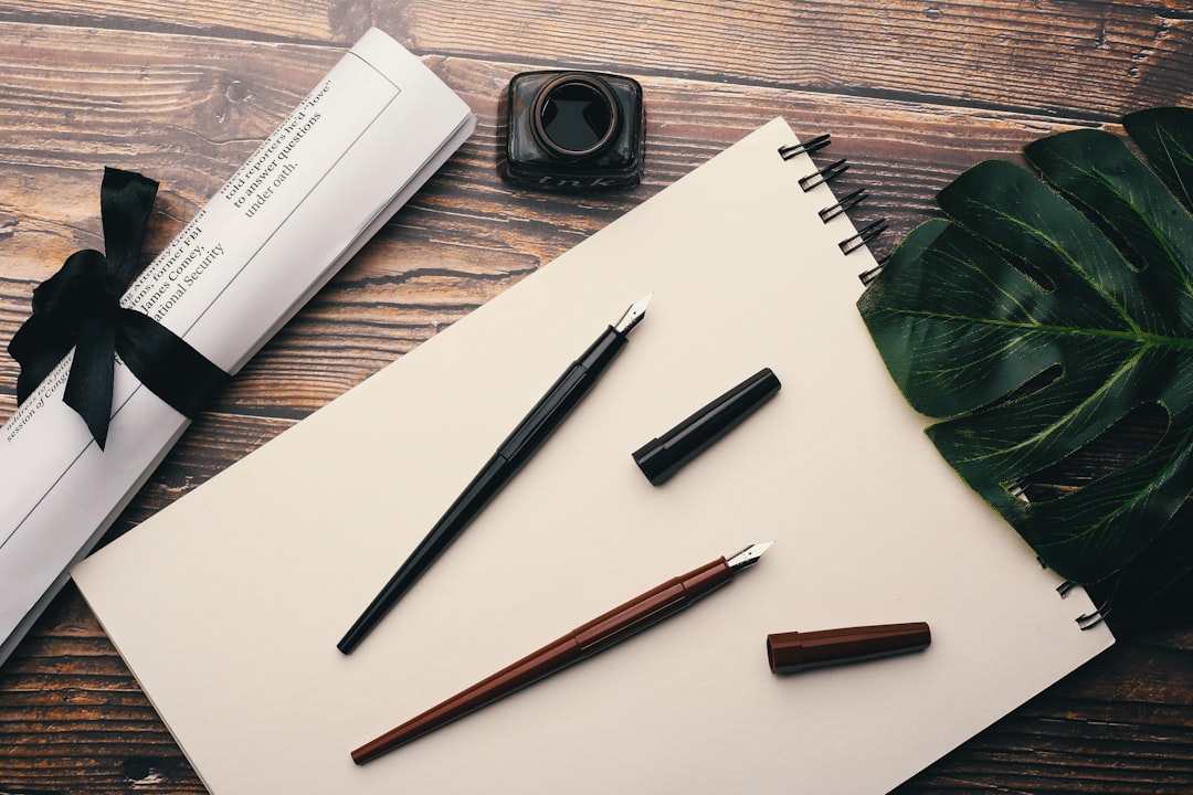 two red and black fountain pens on top of white printer paper mobile design SEO checklist WordPress theme tips - AI Bud