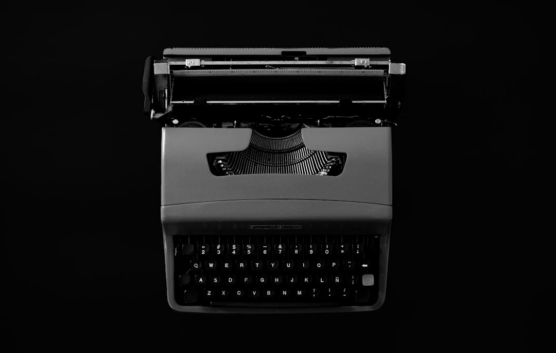 Vintage typewriter on a black background ai writing tool blog creation content automation - AI Bud