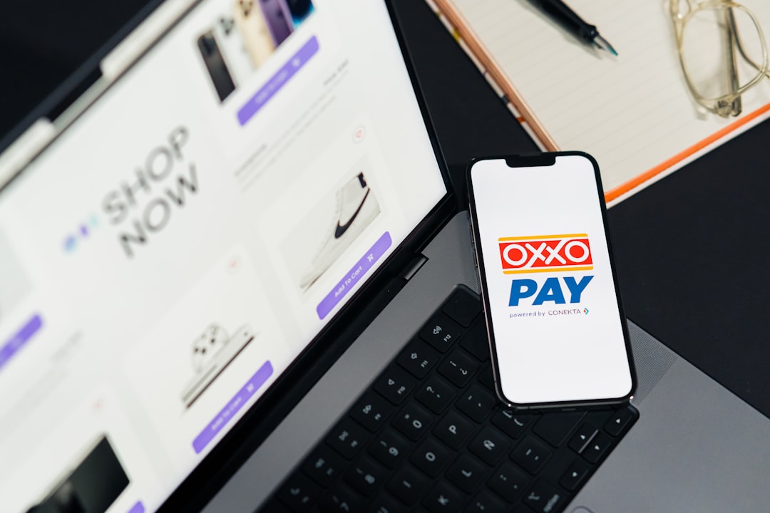 A cell phone sitting on top of a laptop computer payment subscription online checkout - AI Bud