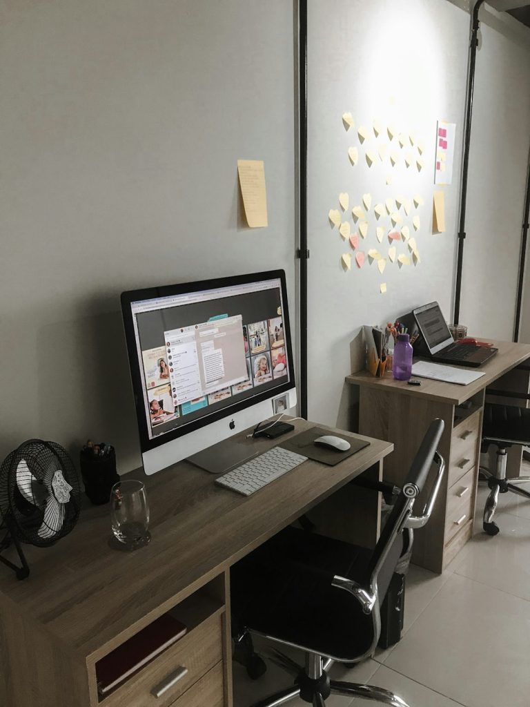 a computer on a desk ai office digital workflow - AI Bud