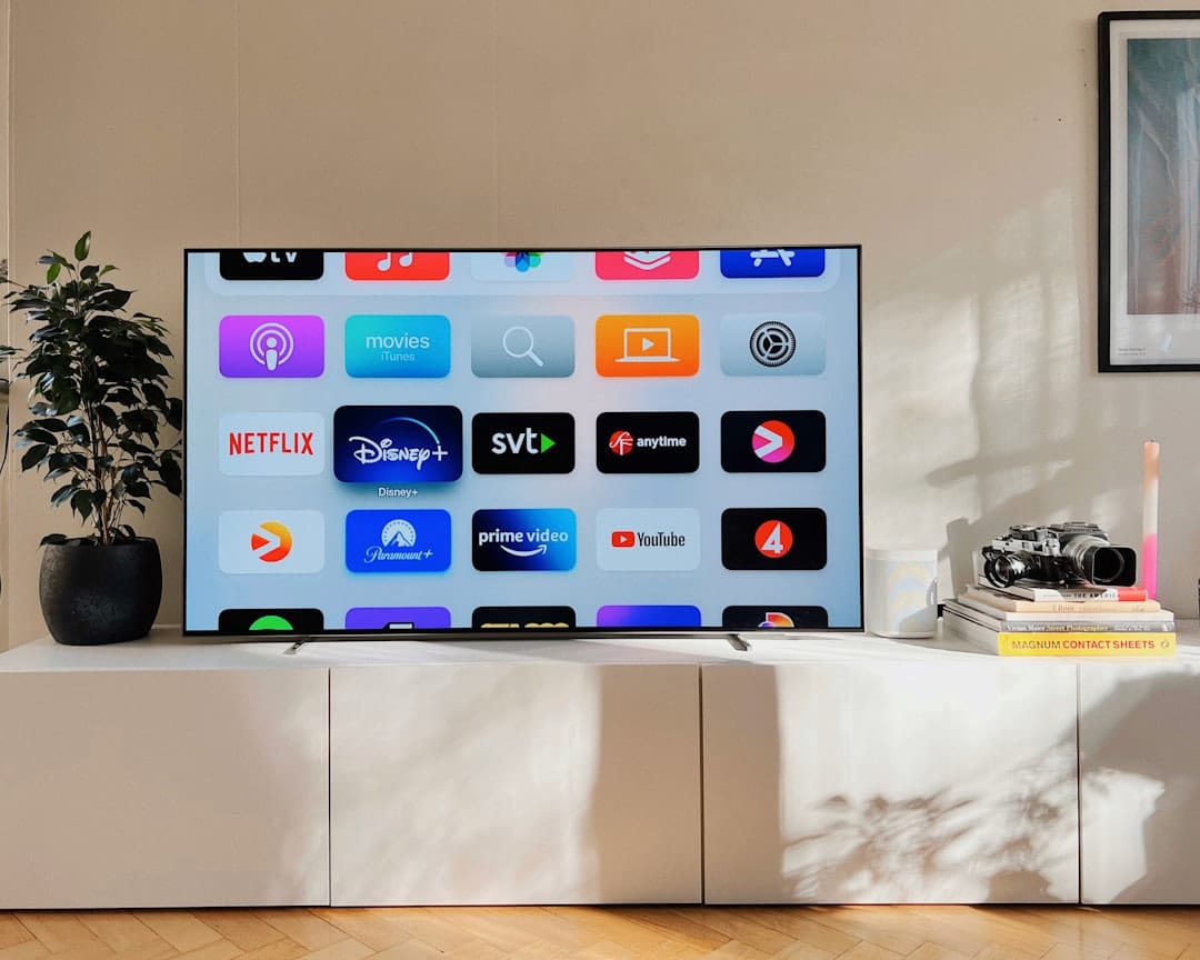 a flat screen tv sitting on top of a white cabinet lg smart tv paramount plus app installation - AI Bud