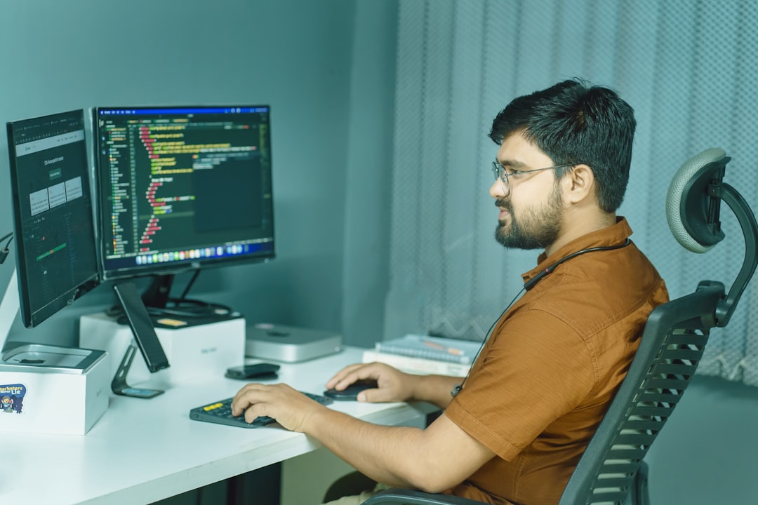 a man sitting at a desk using a computer advanced coding testing quality assurance - AI Bud
