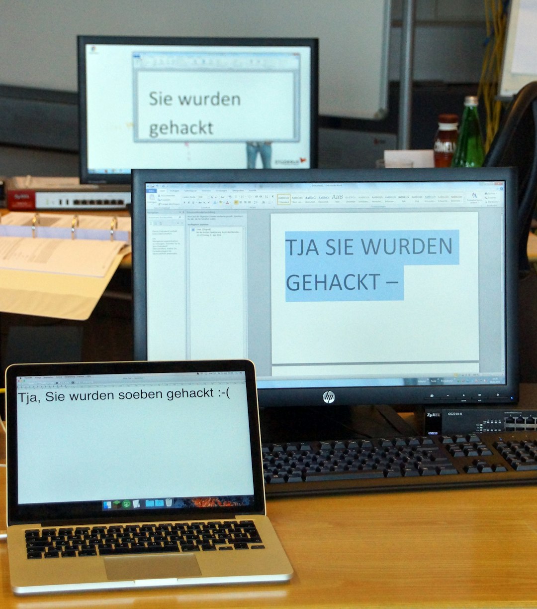A wooden desk topped with a laptop computer next to a monitor ai office digital workflow - AI Bud
