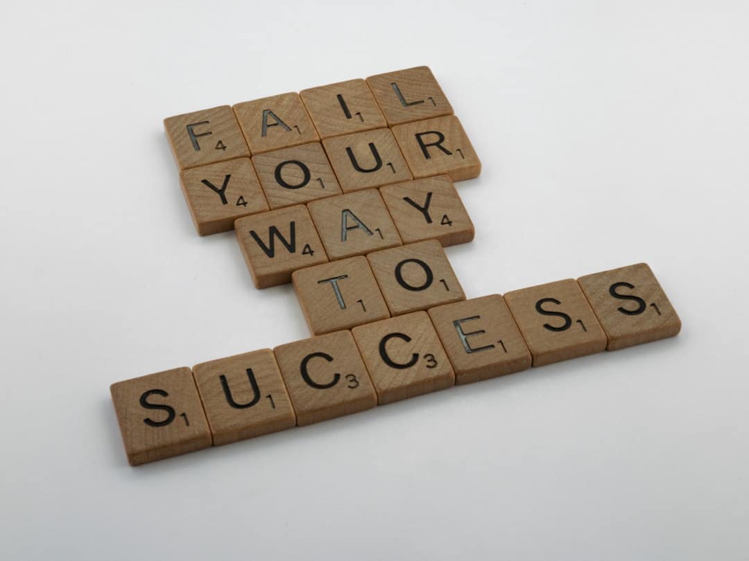 brown wooden blocks on white table inspiration quotes motivation success stories - AI Bud