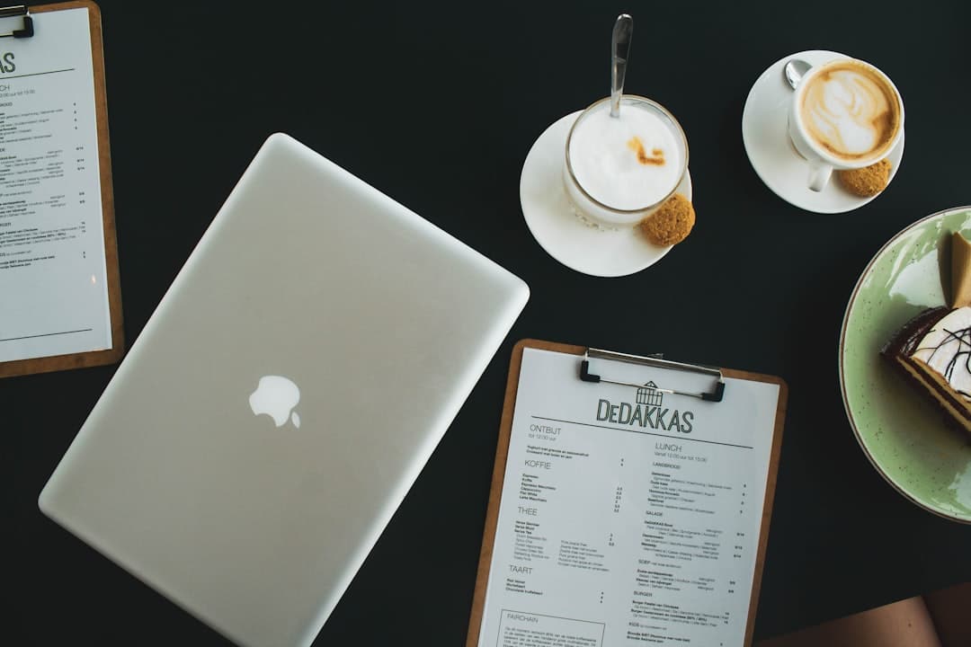 silver macbook beside white ceramic teacup on saucer small business online content AI technology - AI Bud