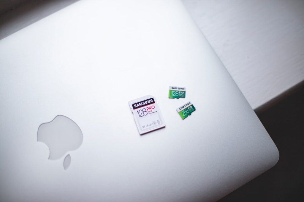 white macbook on brown wooden table smart card usb port windows laptop - AI Bud