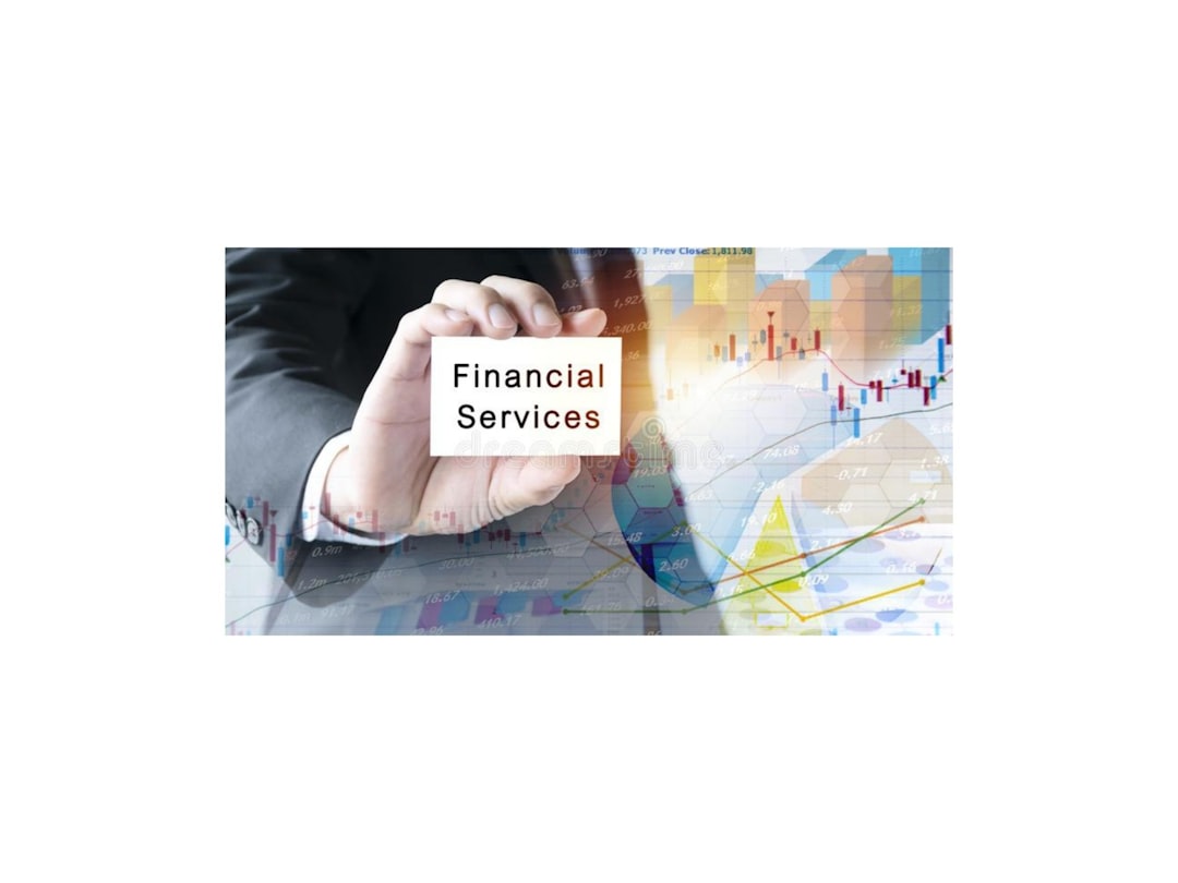 Hand holding a card labeled 'Financial Services' with stock charts in the background.