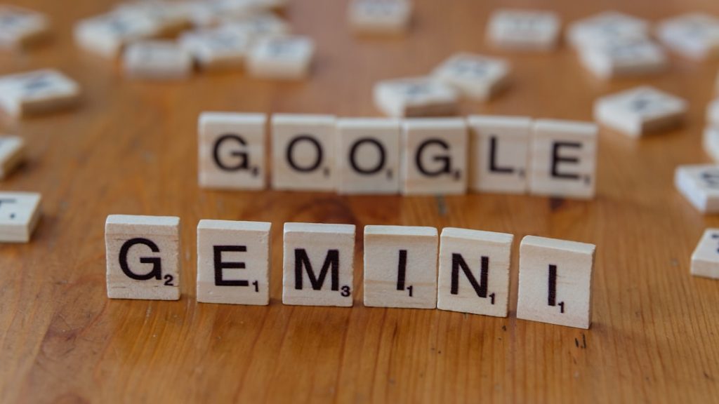 A wooden table topped with scrabble tiles spelling google genni and seo penalty google algorithm website ranking drop - AI Bud