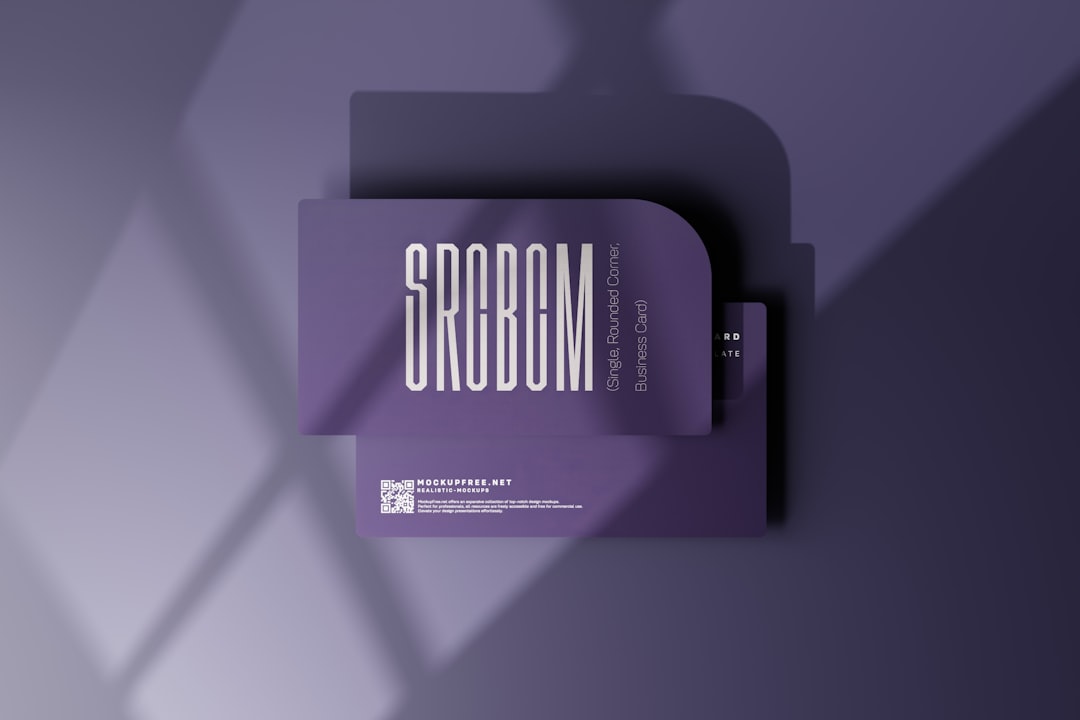 Stack of purple business cards arranged in a layered mockup with bold vertical lettering on the front card.