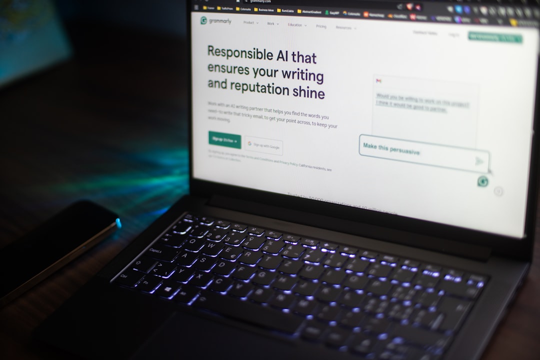 Laptop screen showing a Grammarly page about Responsible AI that ensures your writing and reputation shine, with a blue backlit keyboard visible and a smartphone nearby on the left.