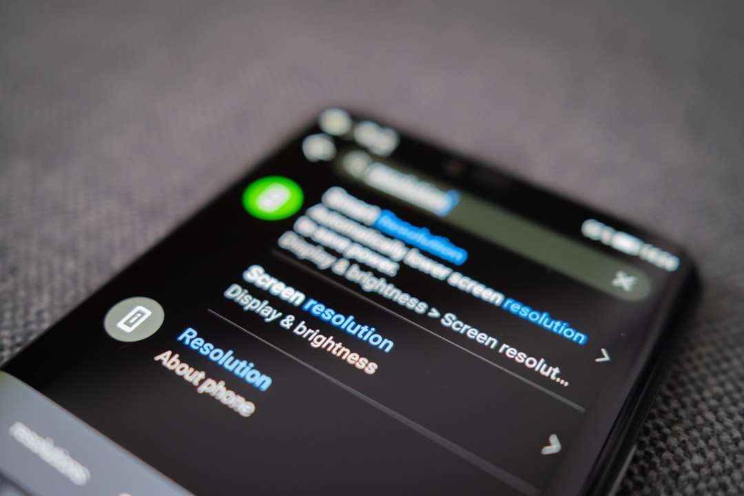 Close-up of a smartphone displaying the 'Screen resolution' option in the Settings app (Display & brightness).