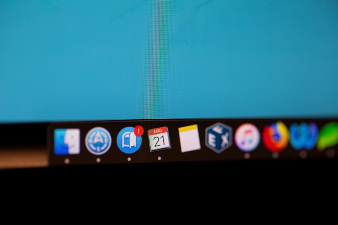 Close-up of a Mac dock with app icons on a blue screen, including a calendar showing May 21 and a red notification badge.