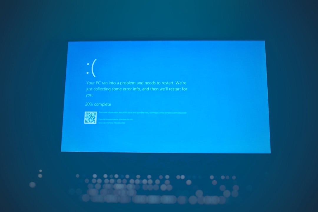 Blue Windows error screen with a sad face, 20% complete, and a QR code in the lower left area.